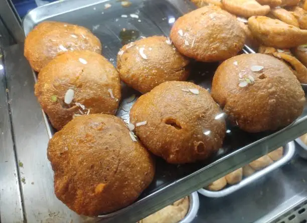 Photo of Sweet kachori is a deep fried Indian snack with sweet lip smaking filling inside with dry fruits, sooji, sugar, and coconut powder.