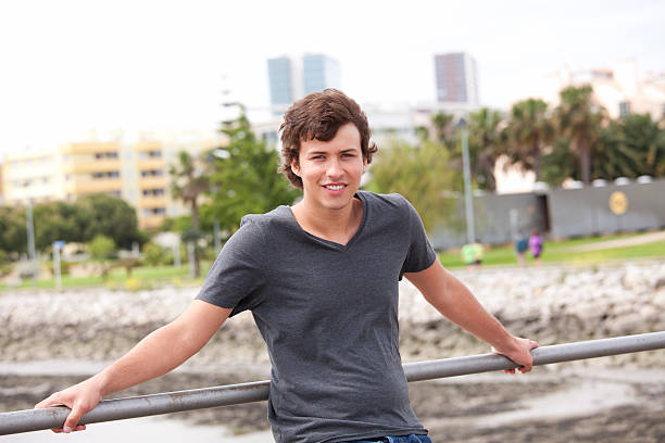 Handsome teenager in a city park