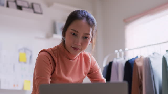 Young asian beautiful woman  checking order in digital tablet for shipping to customer