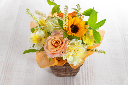 A closeup shot of colorful ranunculus buds in a glass vase