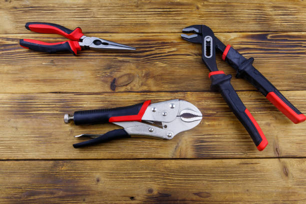 istock Set of different pliers on wooden background. Top view 1498025125