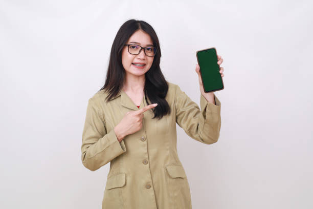 istock Attractive Pretty Indonesian government worker pointing blank cell phone display 1498029979
