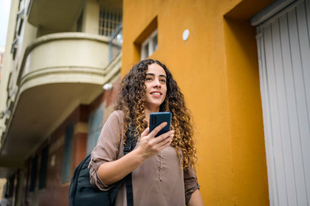 istock A girl on the street using her cell phone 1498031683