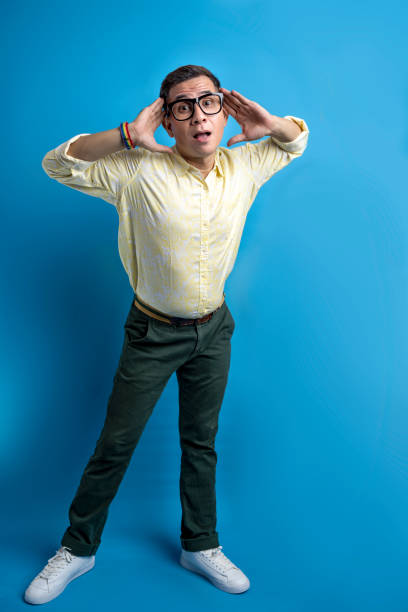istock Man with eyeglasses and a shirt wearing a rainbow bracelet 1498032097