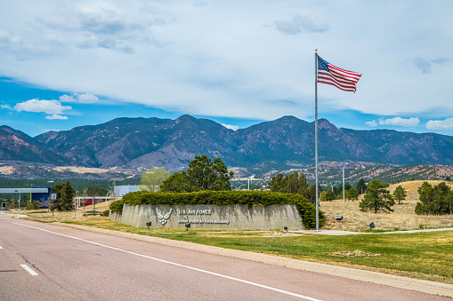 An American flag with Sierra Nevada mountain range in California in the background.