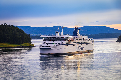 Gulf Islands, British Columbia, Canada - May 28, 2022: BC Ferry travelling through Active Pass, on route from Vancouver Island in the early evening.