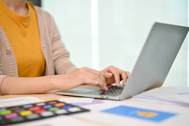 istock Cropped image of a female graphic designer is working on her work on her laptop 1498038833