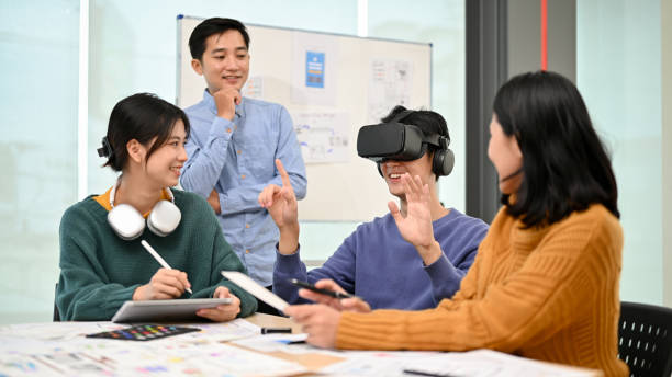 istock A male developer sitting at the table tested a new VR game with virtual reality goggles 1498038917