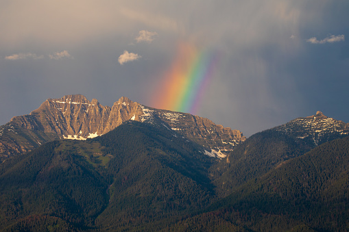 This rainbow appears on the snow covered mountain peak in Montana