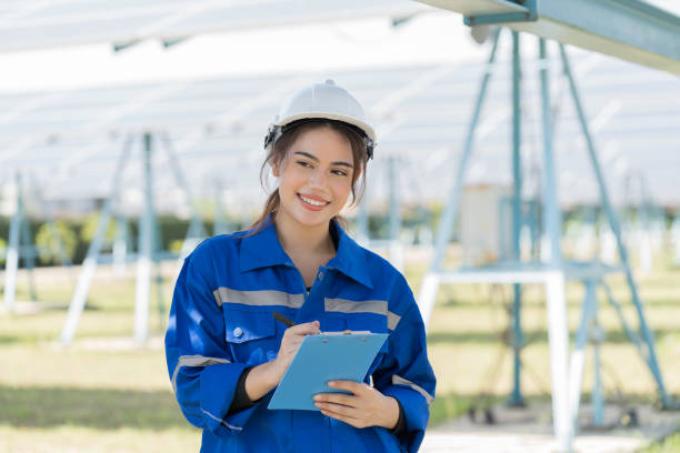 istock Female engineer worker working in solar panels power farm. Technician working at solar power station 1498044101