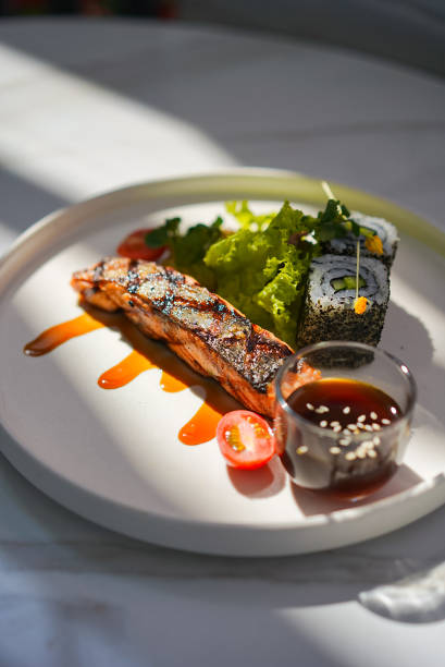 istock Salmon Steak with Vegetables Sushi and Sauce 1498047901