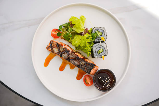 istock Salmon Steak with Vegetables Sushi and Sauce 1498048173