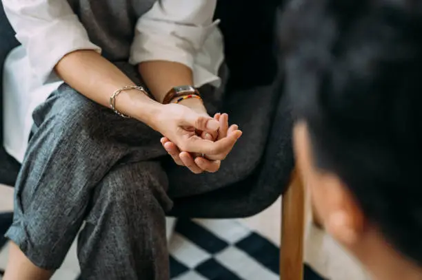 Close-up of woman's hands during counseling meeting with a professional therapist. Close-up of woman's hands during counseling meeting with a professional therapist.