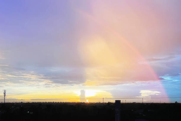 istock Aerial view image of colorful tropical twilight sky and clouds with dramatic sunlight and rainbow curve on silhouette countryside background.Image used for travel business presentation background. 1498050423