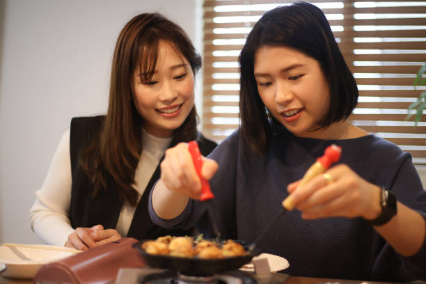 istock woman making takoyaki 1498051142