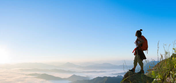 istock hiker standing and watching the sea of mist 1498052523