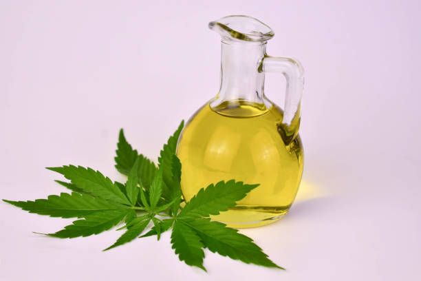 istock Hemp oil in a bottle and hemp seeds on a white background 1498052936