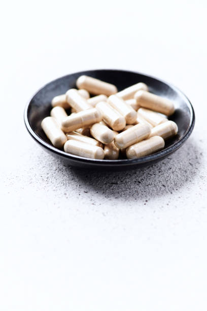 istock Ashwagandha (Withania somnifera) capsules. Bright paper background. Close up. Copy space. 1498053996