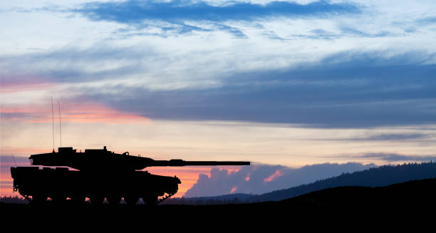 istock Silhouette of army tank at sunset sky background. 1498054195