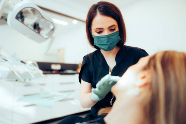 istock Dentist Consulting a Patient in her Dental Office Workplace 1498054574