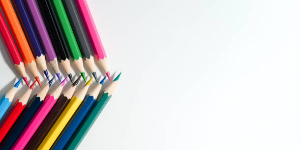 istock Colored pencils lying over paper, flat lay. 1498057225