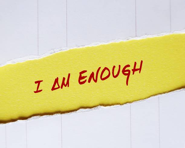 istock Ripped torn yellow paper with handwritten text I AM ENOUGH concept of self-acceptance, affirmation to tell yourself you are good enough and capable enough to become everything you want to be 1498060071