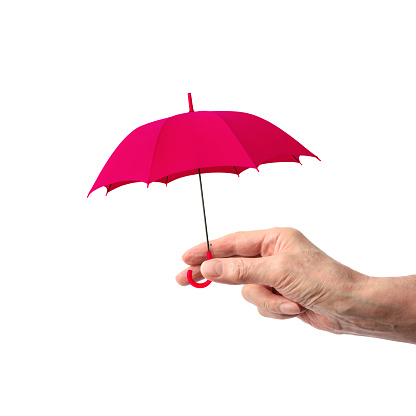 Close-up of hand holding a small pink umbrella on a white background.