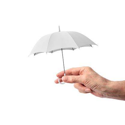 Close-up of hand holding a small white umbrella on a white background.