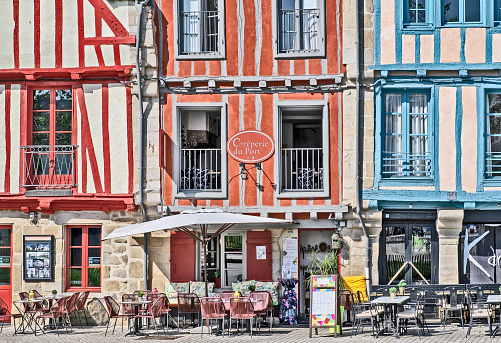 Vannes, France - May 21, 2023: Frontal view of local architecture with restaurants in Vannes, France.
