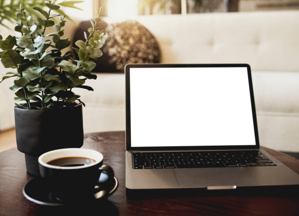 istock A laptop computer and a cup of coffee on a wooden office table. Stock image. 1498065635
