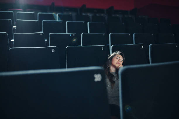 istock Young woman fell asleep in cinema. 1498066042