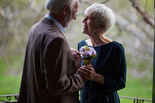 Happy senior couple enjoying in romantic moment on a terrace.