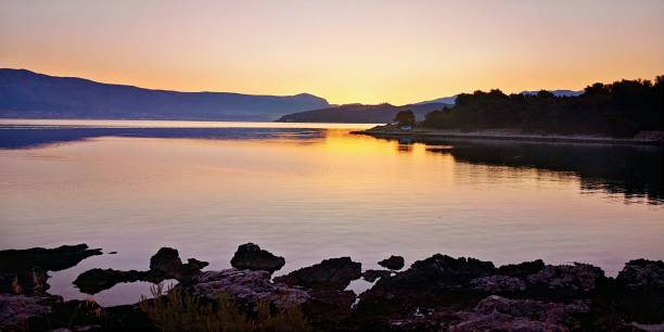 istock Beautiful sunset over a serene mountain lake 1498073012