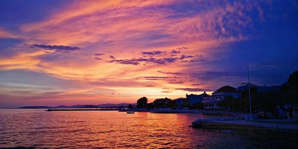 istock Beautiful landscape featuring a peaceful bay with a golden sunset reflecting off the calm water 1498073018