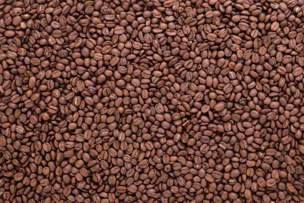 istock Freshly roasted coffee beans background top view using for your advertising 1498073383