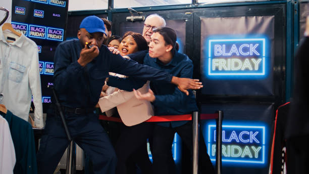 istock Black friday shoppers argue at entrance 1498073710