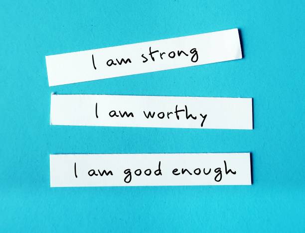 Three note paper on blue background with handwritten text I AM STRONG, I AM WORTHY, I AM ENOUGH - powerful self talk positive affirmations to boost self confidence self esteem