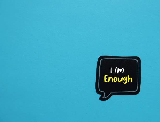 istock Speech sticker on copy space blue background with handwritten text I Am Enough - Positive self talk affirmation mantra to boost self belief and self esteem 1498073993