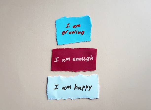 istock Torn paper note with handwritten text I AM GROWING I AM ENOUGH I AM HAPPY - positive affirmations self talk practice for daily encouragement and boost self esteem - optimistic voice remind to look on the bright side 1498074224
