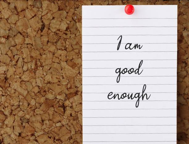 istock Note pinned on cork board with text written I AM GOOD ENOUGH , aspiration motivation self talk to boost self esteem ,encourage self-worth. 1498074786