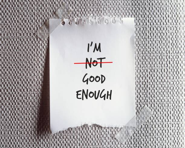 istock Torn note paper written I AM NOT GOOD ENOUGH , change to I AM GOOD ENOUGH , concept pf self improvement by boosting self esteem and change negative inner perception to be positive one 1498074815
