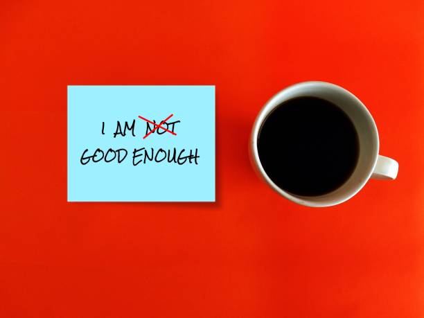 istock Coffee cup and blue note with text written I AM NOT GOOD ENOUGH with red cross on NOT, an aspiration motivation self talk to boost self esteem ,encourage self-worth. 1498074872