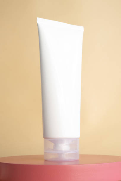 istock Blank white cosmetic tube mockup on podium 1498075871