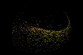 A large number of gold particles converged on the black background