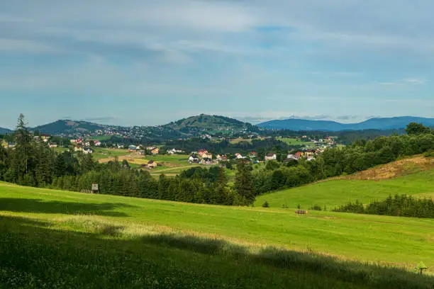 Jaworzynka village with hills on the background in Beskid mountains in Poland during beautiful summer evening
