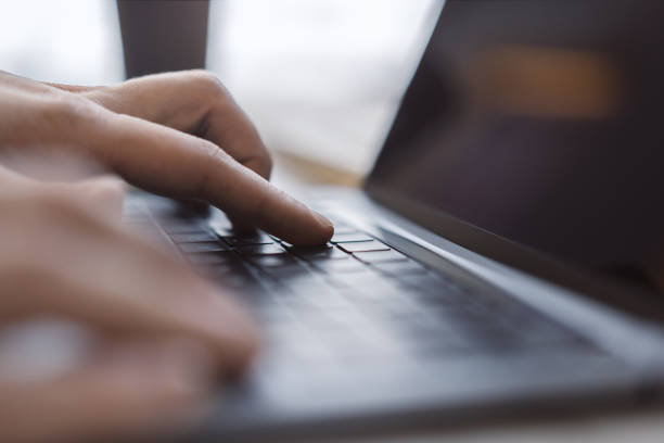 istock A man's hands are captured up close, busily typing on a sleek laptop keyboard, set against a fuzzy office background 1498083401