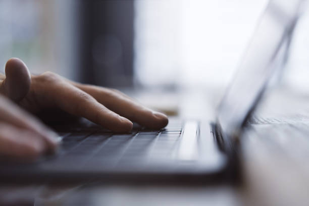 istock A man's hands are captured up close, busily typing on a sleek laptop keyboard, set against a fuzzy office background 1498083408