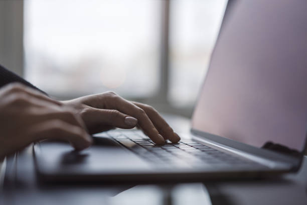 istock Against a blurred office background, the image captures a woman's hands typing on a sleek laptop keyboard 1498084026