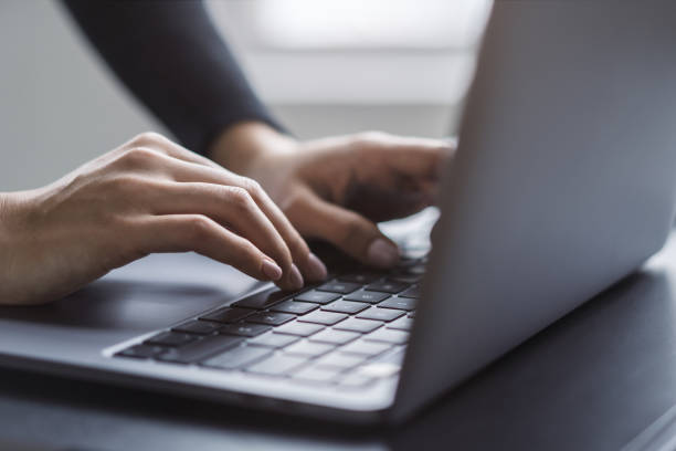 istock In the blurred setting of an office, a close-up shot captures a woman's hands typing on a modern laptop keyboard 1498084107