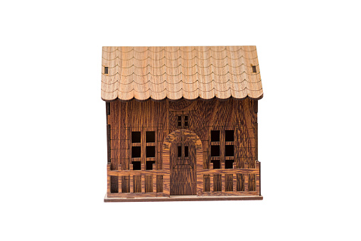 wooden miniature house isolated on the white background for real estate and construction concepts.
